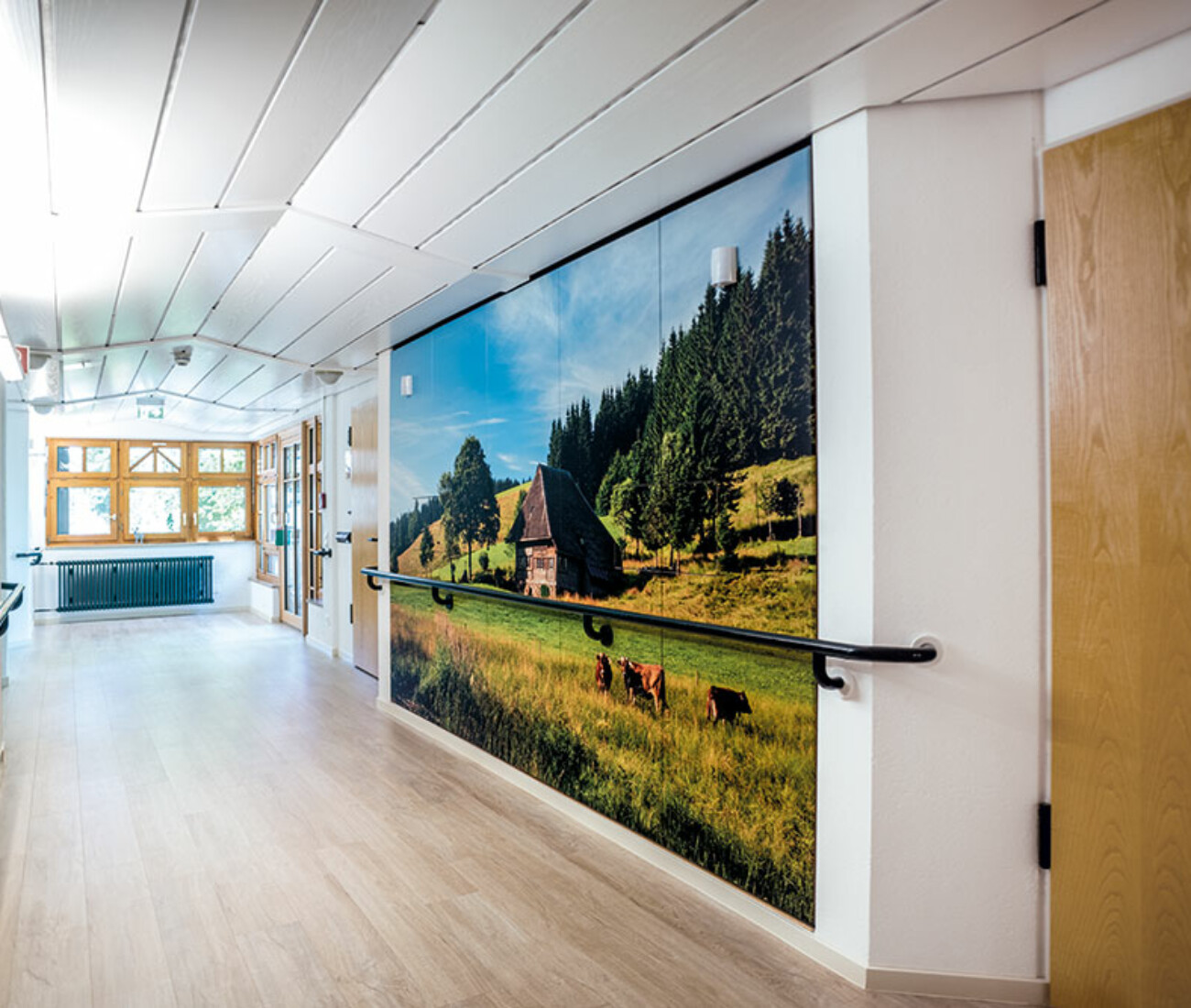 Hell erleuchteter Pflegeheim‑Flur im HAus Schwearzwald mit Handläufen und großer Fensterfront im Bürgerheim Schwenningen